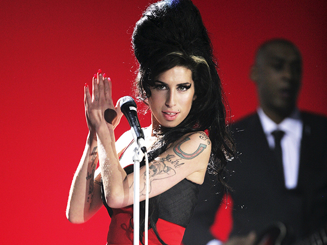 Amy Winehouse performs on stage at The BRIT Awards 2007 in association with MasterCard at Earls Court 1 on February 14, 2007 in London, England. (Photo by Dave Hogan/Getty Images)